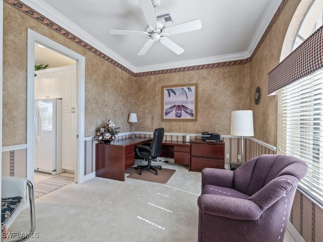 office featuring wallpapered walls, visible vents, light colored carpet, ceiling fan, and crown molding