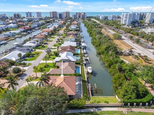 birds eye view of property with a water view and a city view