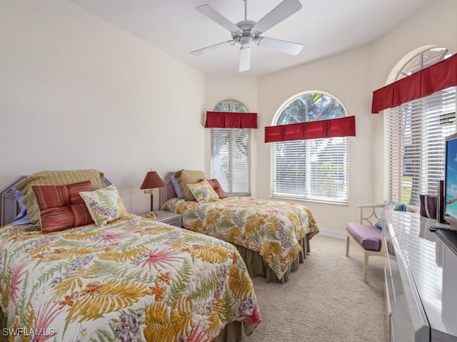 bedroom featuring carpet floors, baseboards, and a ceiling fan