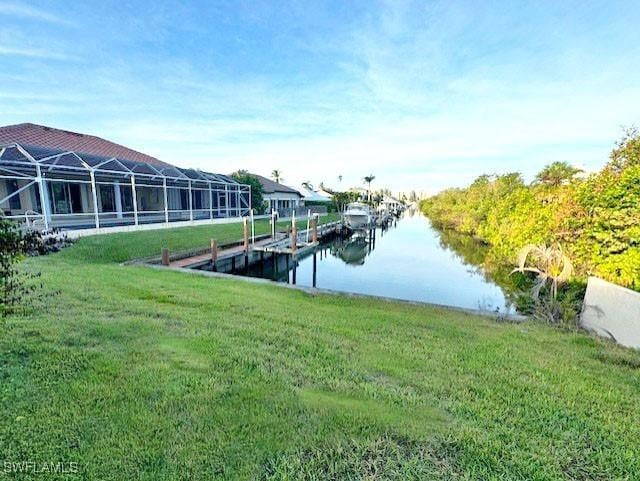 view of dock featuring a water view and a yard