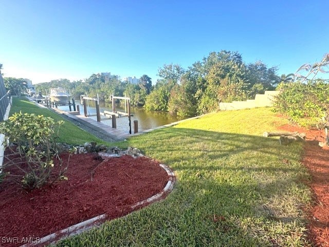 view of yard featuring a boat dock and a water view