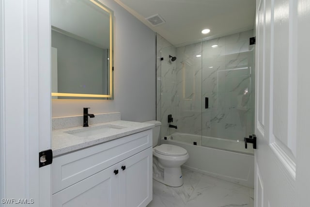 full bathroom featuring shower / bath combination with glass door, vanity, and toilet