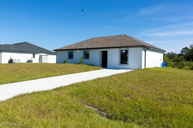 rear view of property featuring a lawn