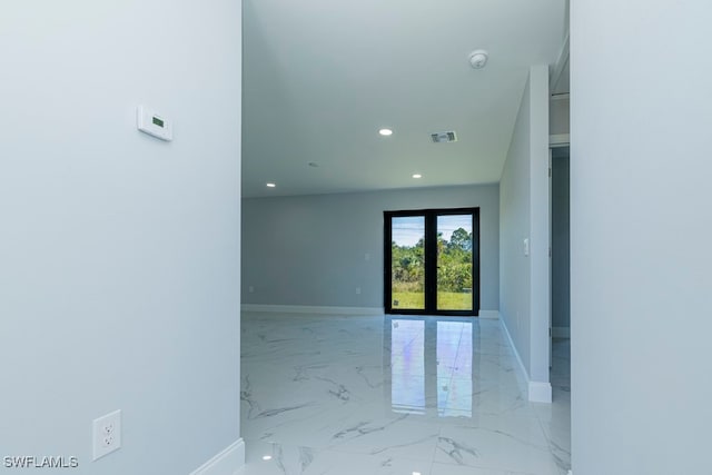 unfurnished room featuring french doors