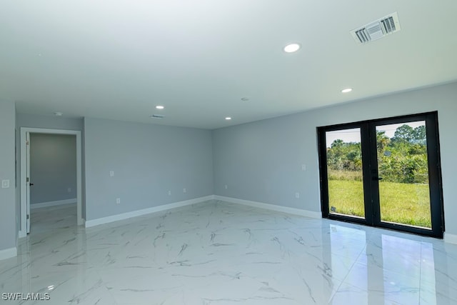 unfurnished room with french doors