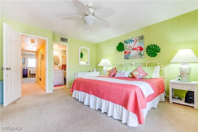 carpeted bedroom featuring ensuite bath and ceiling fan