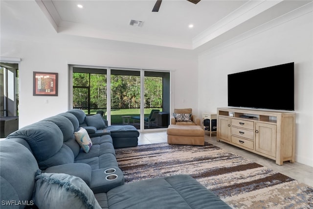 tiled living room featuring a tray ceiling and ceiling fan