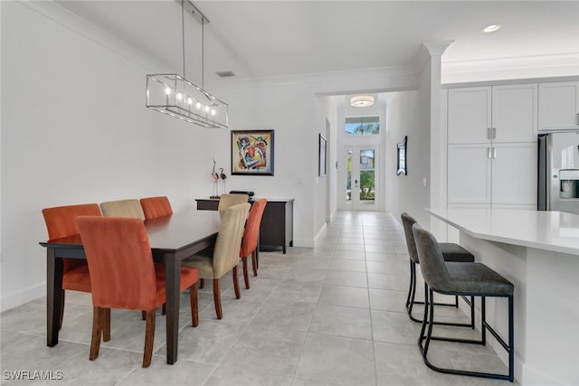 tiled dining area featuring crown molding