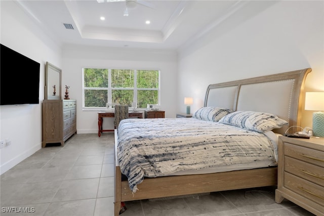 tiled bedroom featuring a raised ceiling, ceiling fan, and crown molding