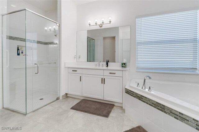 bathroom with tile patterned flooring, vanity, and shower with separate bathtub