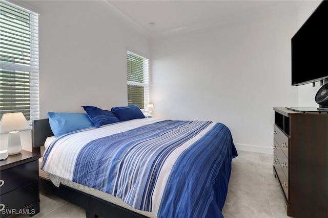 bedroom featuring light tile patterned floors and multiple windows