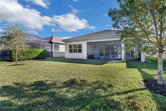 rear view of property featuring a yard