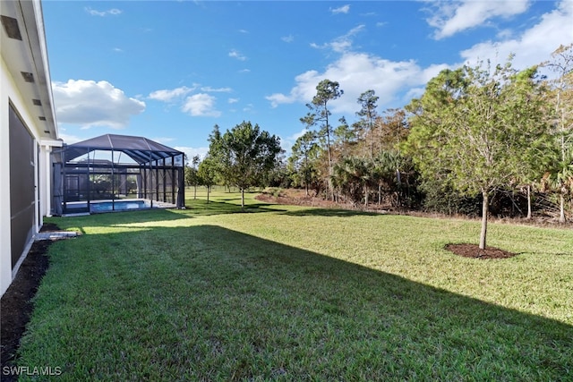 view of yard featuring glass enclosure