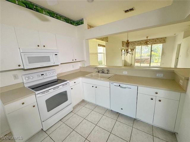 kitchen featuring sink, decorative light fixtures, a chandelier, white appliances, and white cabinets