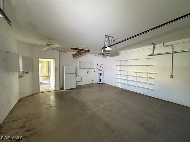 garage with a garage door opener, white fridge, electric water heater, and ceiling fan