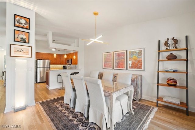 dining room with a chandelier and light hardwood / wood-style flooring