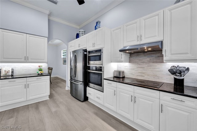 kitchen featuring white cabinets, stainless steel fridge, light wood-type flooring, black electric cooktop, and tasteful backsplash