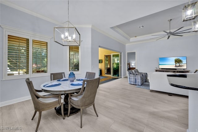 dining area featuring ceiling fan with notable chandelier, light hardwood / wood-style floors, and ornamental molding