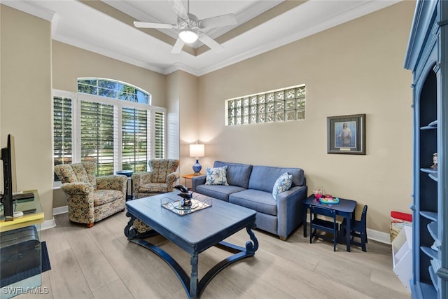 living room with light hardwood / wood-style flooring, ceiling fan, and ornamental molding