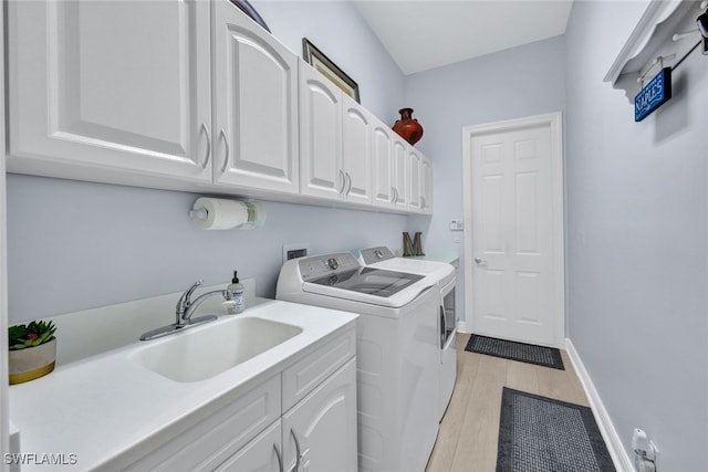5620 Hammock Isles Dr, Naples, FL 34119 - laundry area featuring washer and clothes dryer, cabinet space, and light wood-style flooring