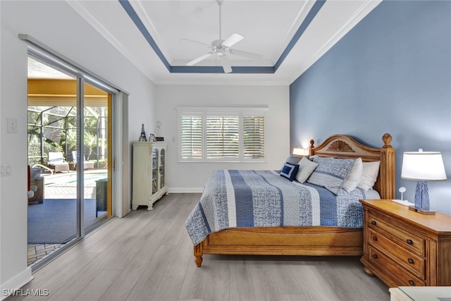 5620 Hammock Isles Dr, Naples, FL 34119 - bedroom featuring access to exterior, wood finished floors, a tray ceiling, a ceiling fan, and crown molding