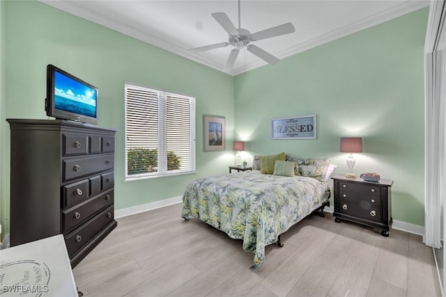 bedroom featuring light hardwood / wood-style floors, ceiling fan, and ornamental molding