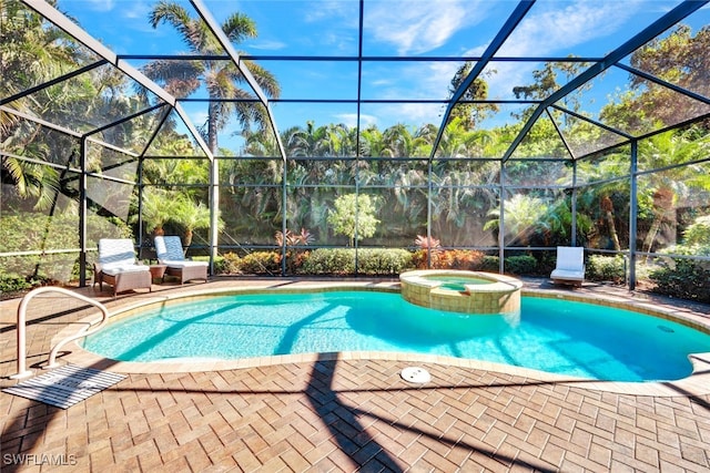 view of swimming pool with glass enclosure, a patio area, and an in ground hot tub