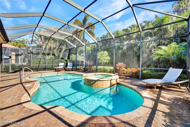 view of pool featuring glass enclosure, a patio area, and an in ground hot tub