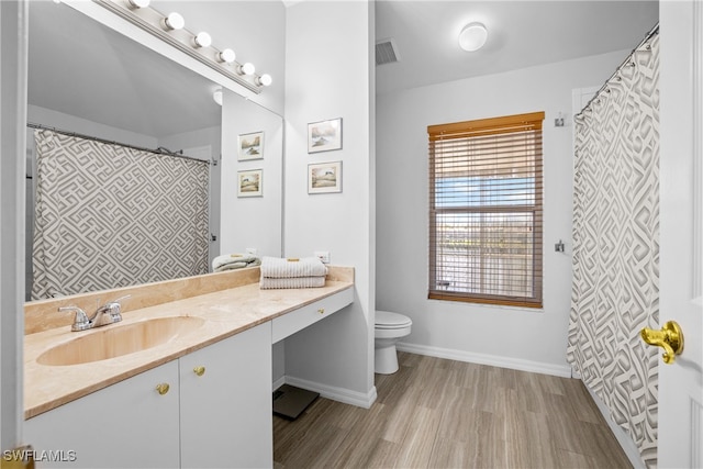 bathroom with vanity, wood-type flooring, and toilet