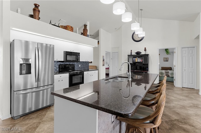 kitchen with sink, white cabinets, black appliances, and high vaulted ceiling