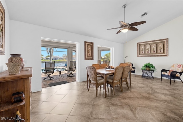 dining room featuring plenty of natural light, ceiling fan, light wood-type flooring, and vaulted ceiling