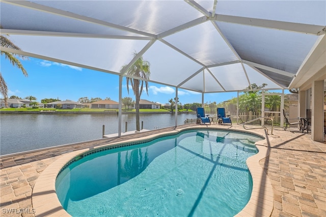 view of pool with a patio, a water view, and a lanai