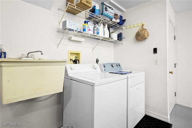 clothes washing area featuring separate washer and dryer