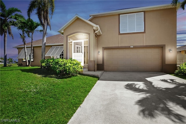 view of front of house with a garage and a lawn