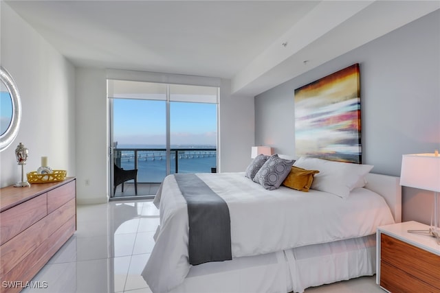 bedroom with access to outside, a water view, and light tile patterned floors