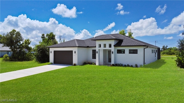 prairie-style home with a front yard and a garage