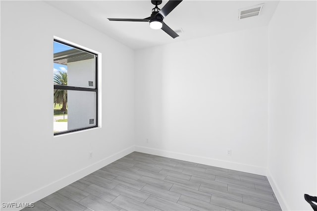 spare room with light hardwood / wood-style floors and ceiling fan