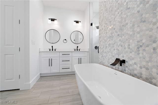 bathroom with hardwood / wood-style flooring, vanity, and separate shower and tub