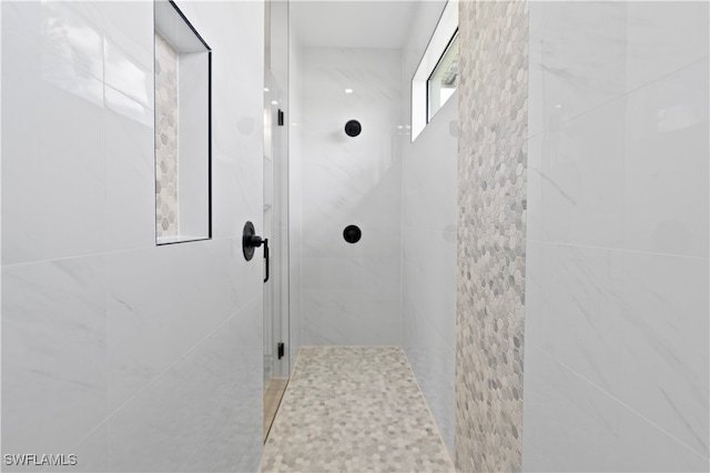 bathroom with a tile shower