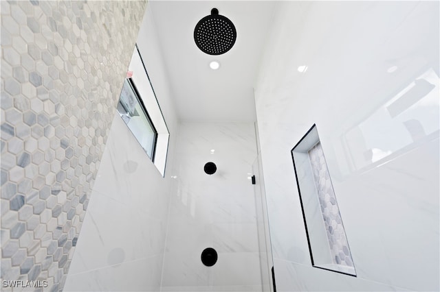 bathroom with tiled shower