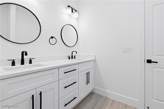 bathroom with vanity and wood-type flooring