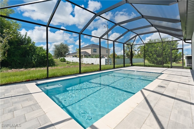 view of pool featuring a patio and glass enclosure