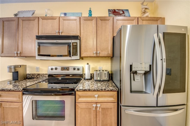 kitchen with light brown cabinetry, appliances with stainless steel finishes, and stone counters