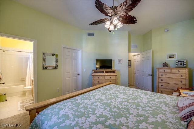 tiled bedroom with ceiling fan and ensuite bath