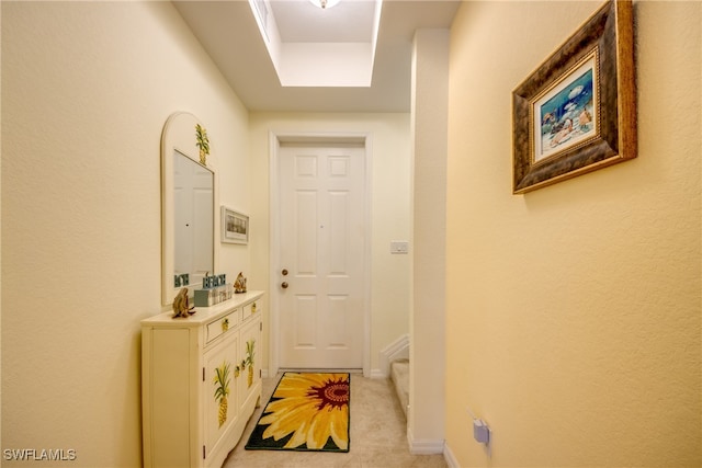 entryway with light colored carpet