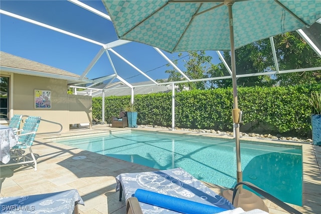 view of pool with a lanai and a patio