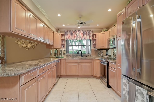 kitchen featuring ceiling fan, light tile patterned floors, stainless steel appliances, and ornamental molding