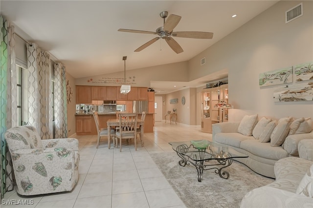 tiled living room featuring ceiling fan and high vaulted ceiling