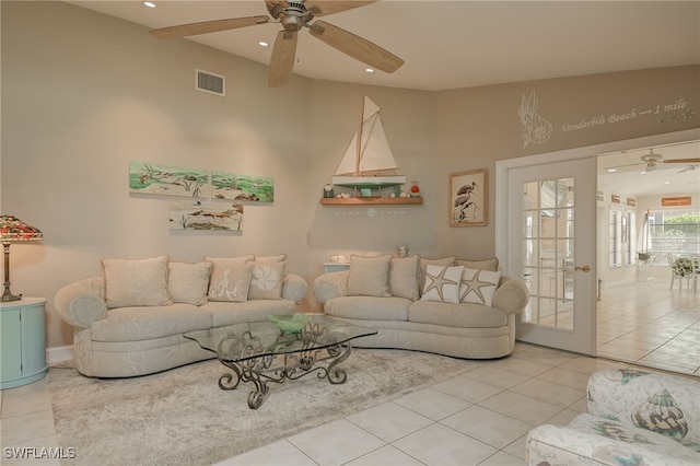 living room featuring ceiling fan and tile patterned flooring