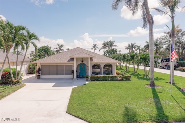 mediterranean / spanish-style home with a garage and a front yard